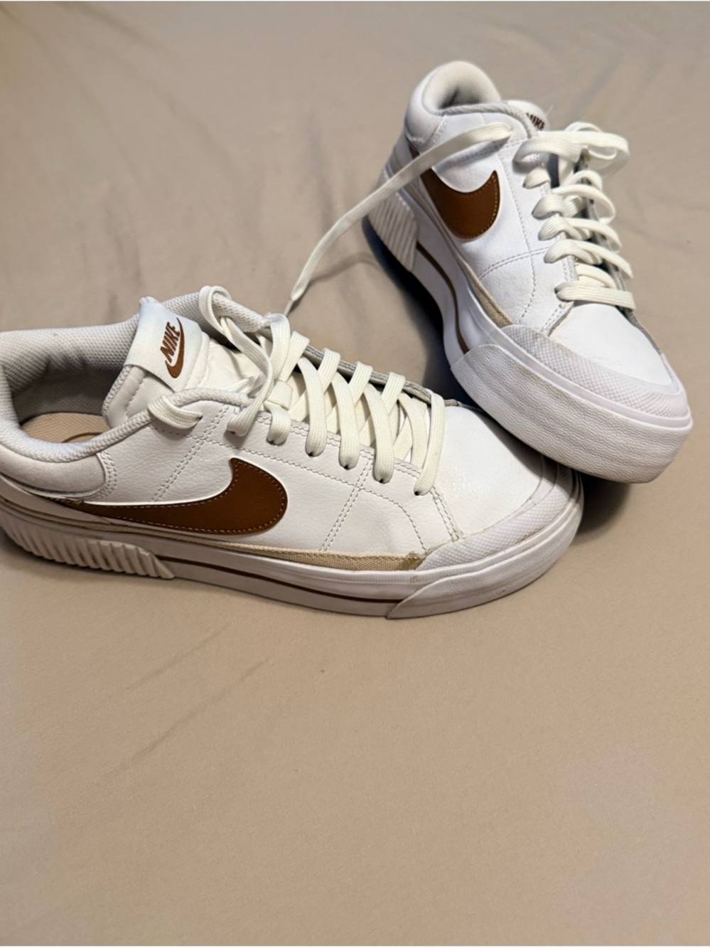 Nike White Sneakers with Brown Swoosh Accents